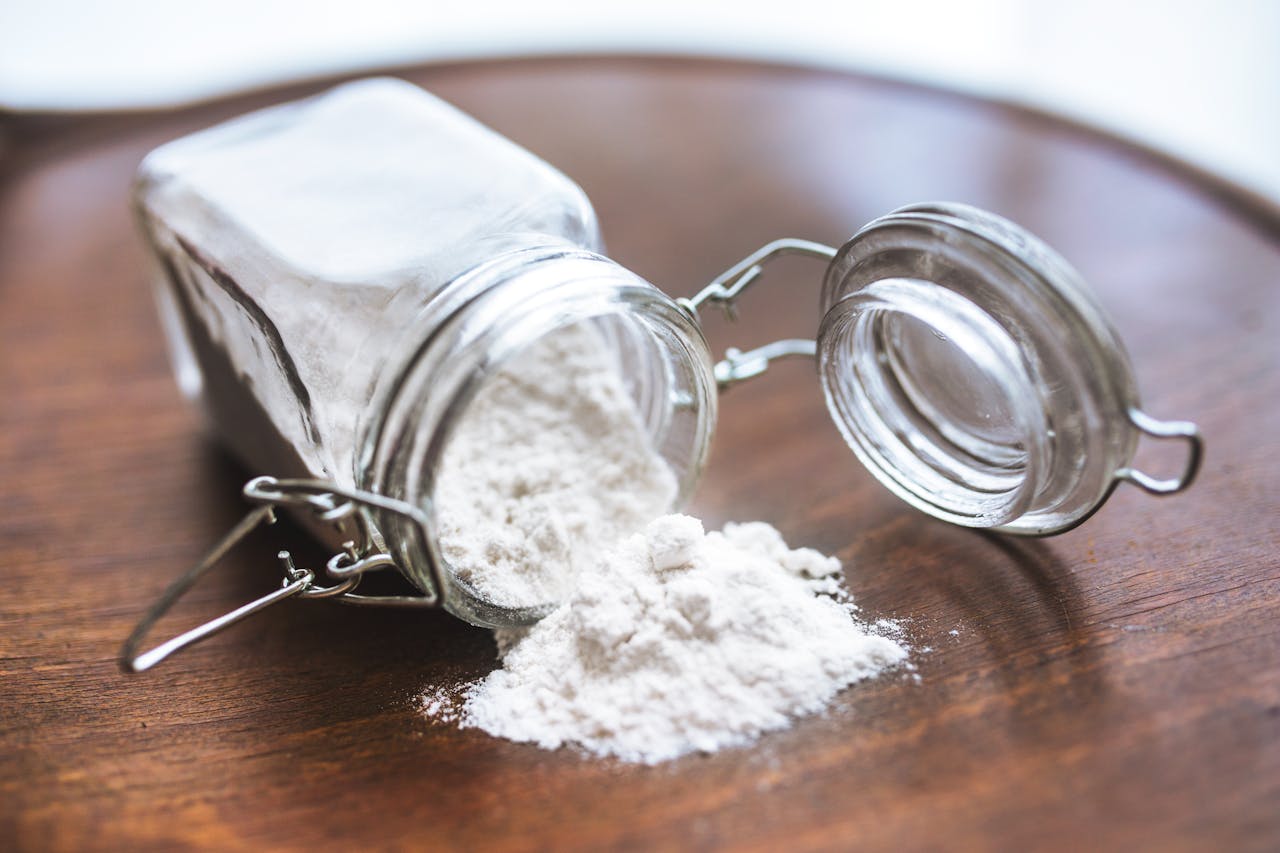 baking soda in a jar spilled over table